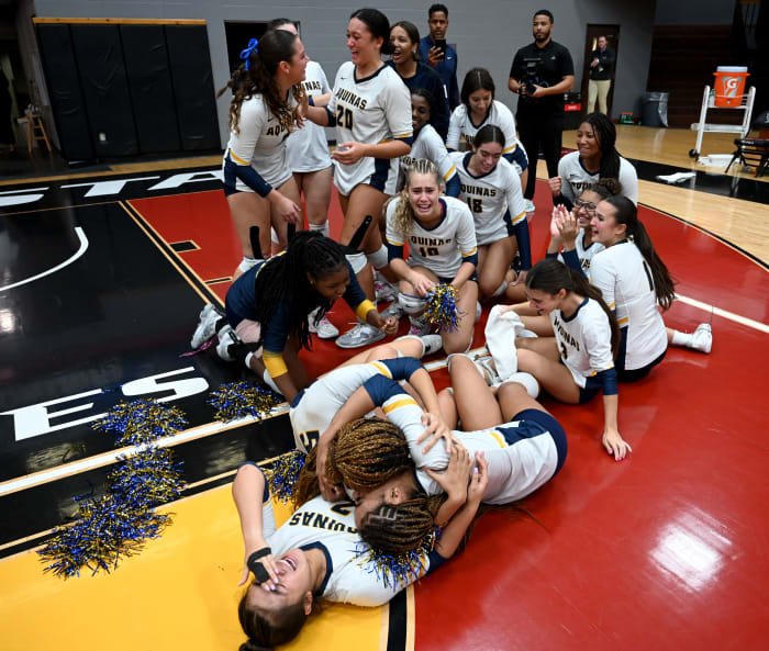 St. Thomas Aquinas players celebrate on the Polk State College floor after winning the Class 6A state championship match at the FHSAA girls volleyball state tournament on Thursday.